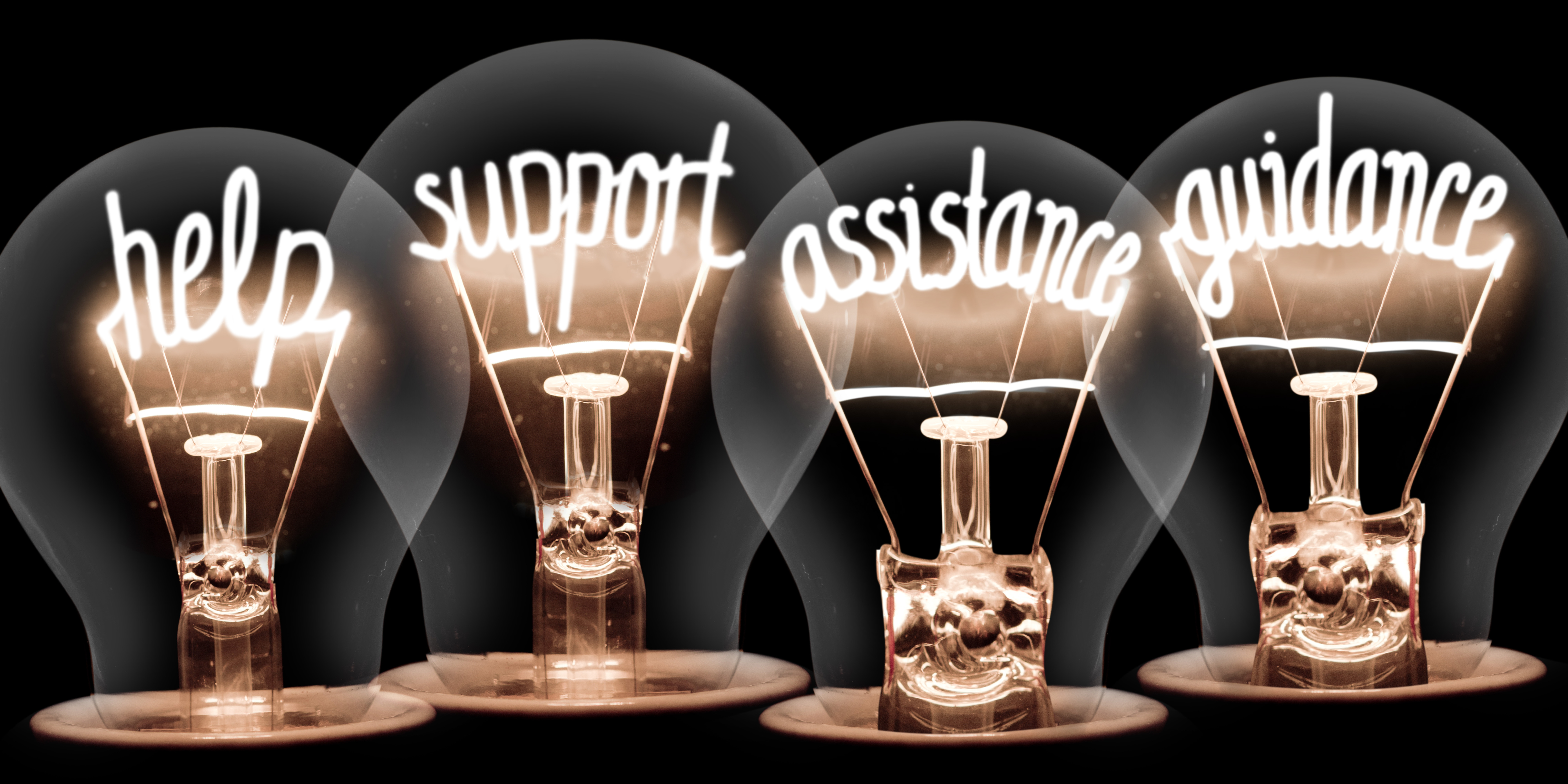 Photo of light bulbs group with shining fibers in a shape of HELP, SUPPORT, ASSISTANCE, GUIDANCE concept words isolated on black background